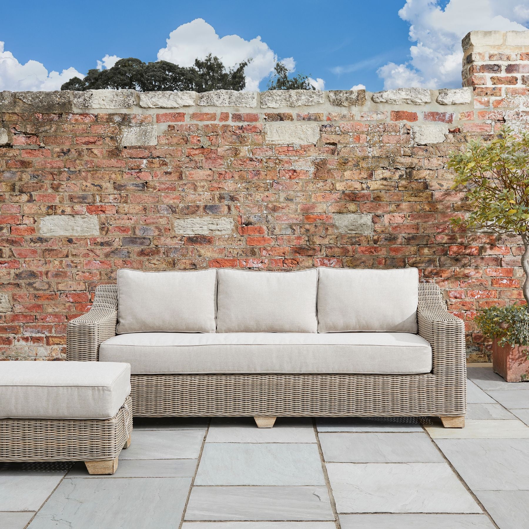 Capri Collection Outdoor Three Seater Sofa in garden