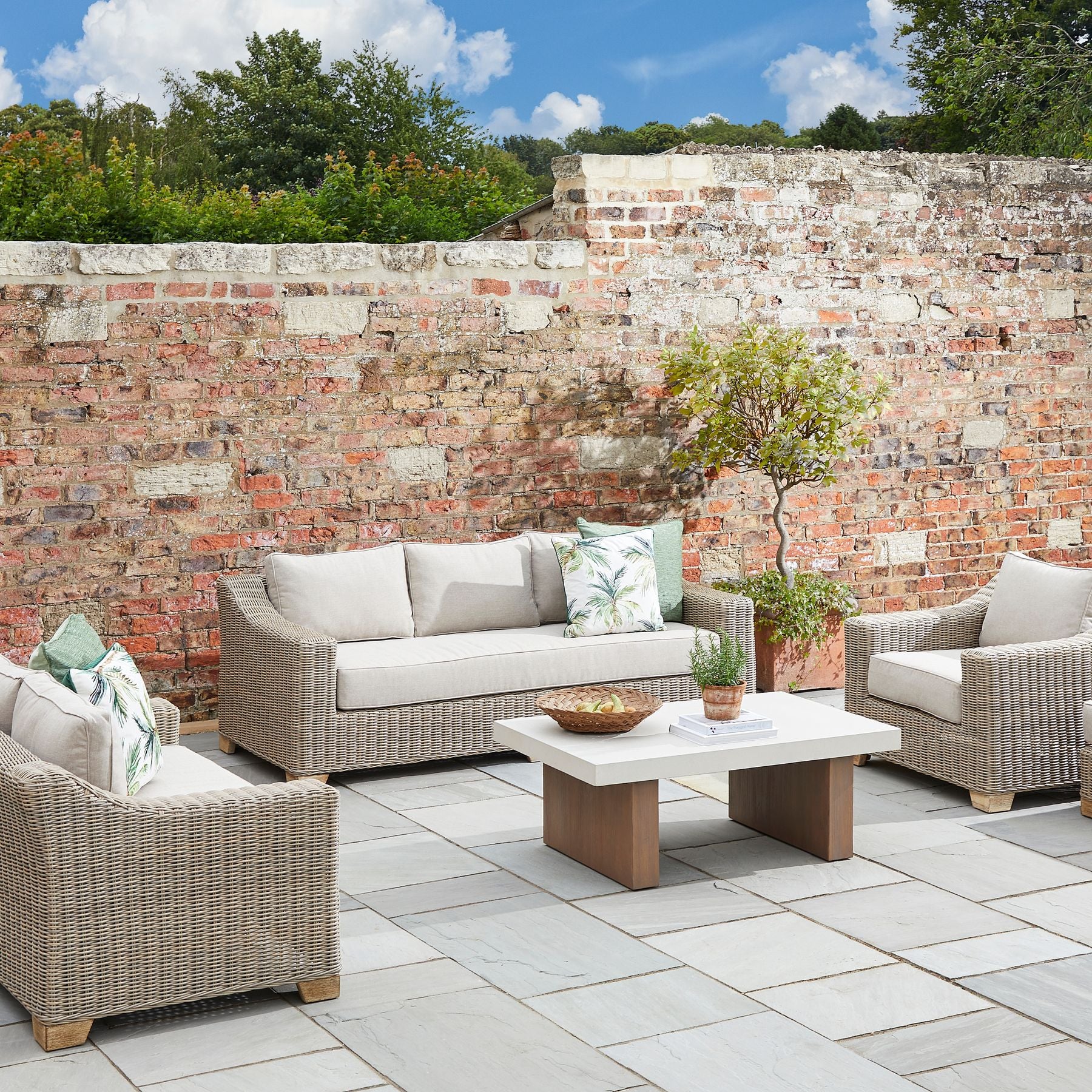 Capri Collection Outdoor Three Seater Sofa in garden